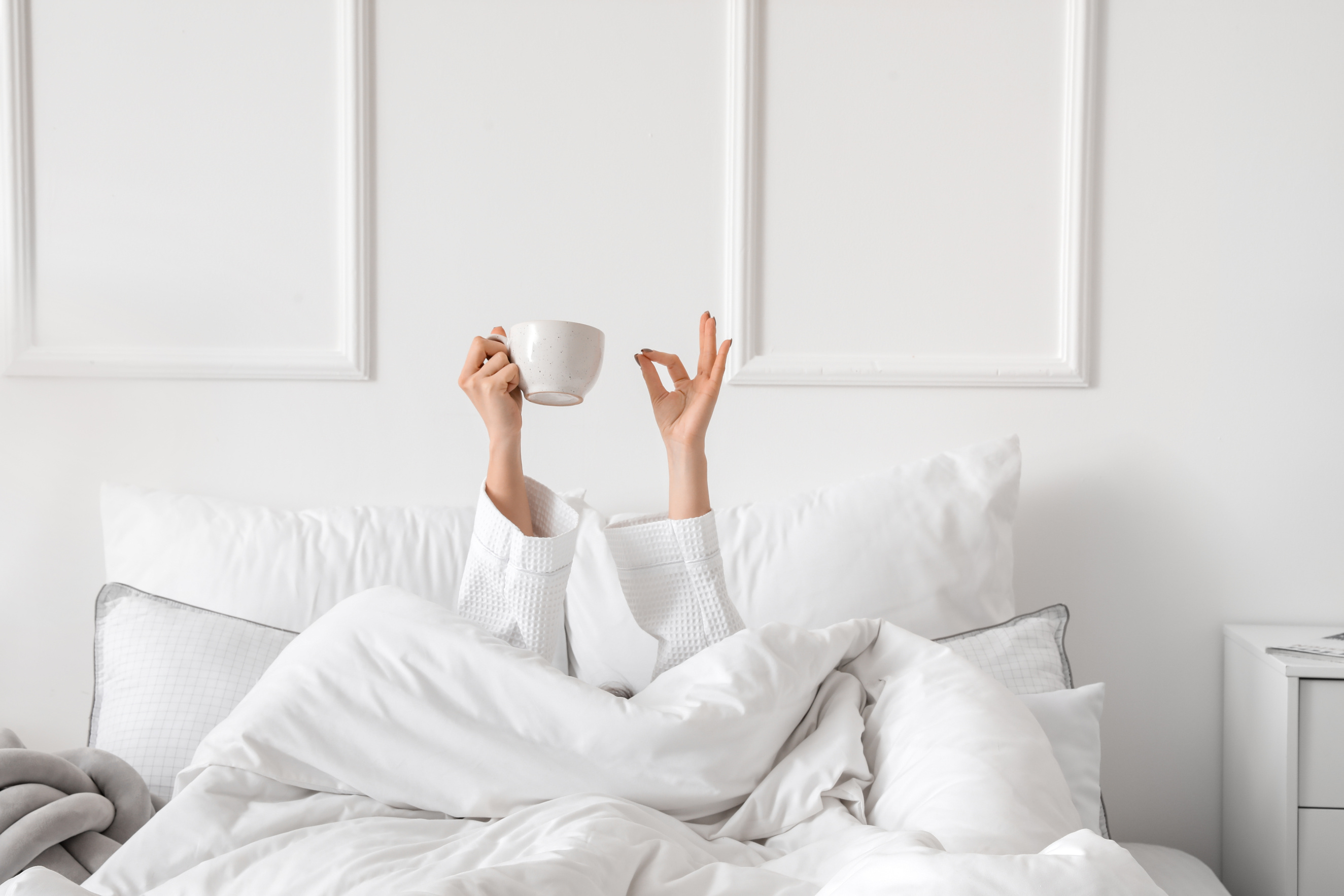 Morning of Young Woman Drinking Tea in Bed